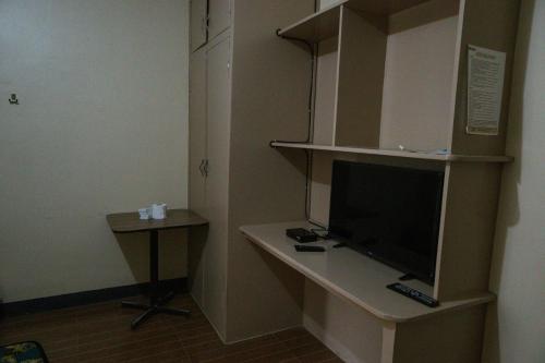 a room with a desk with a computer on it at Villa Elsie Resort and Hotel in General Trias