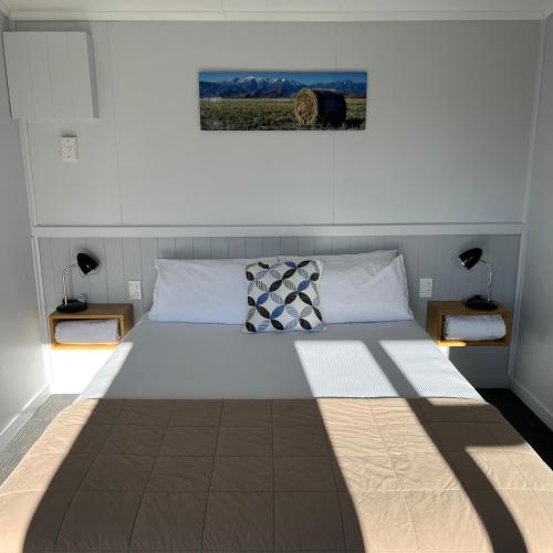 a bedroom with a large bed with two night stands at Omarama TOP10 Holiday Park in Omarama
