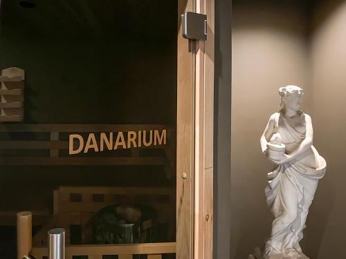 a statue of a woman standing in a window at Boutiquehotel Goldhahn Bio Sport & Wellness in Aalen