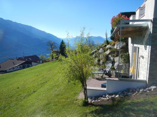 a house on the side of a hill next to the water at Ferienwohnung Moralé in Seefeld in Tirol