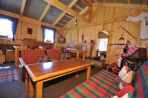 a living room with a table and chairs at Penzion Úsmev in Arnutovce
