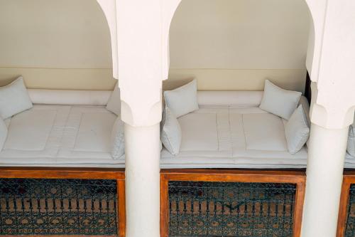 a couch in a room with two columns at Riad Dar Zaouia in Marrakech