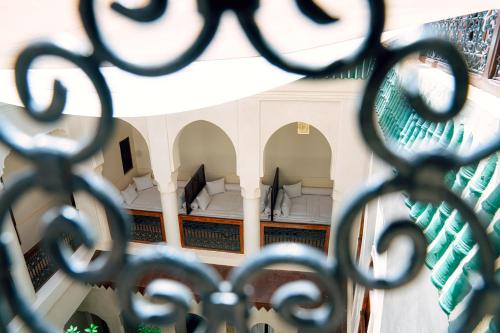 a view of a building through a iron fence at Riad Dar Zaouia in Marrakech
