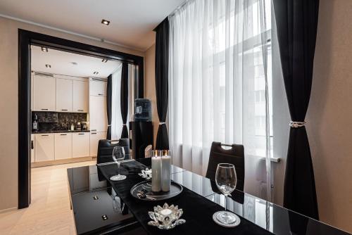 a dining room with a table and chairs and a window at LuxeCityApartment in Tallinn