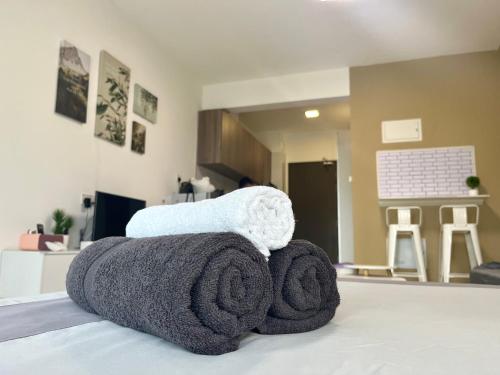 a couple of towels sitting on top of a room at 1-2pax CozyStudio,Central Park Jb townCIQ, Free Netflix,Wi-Fi,Youtube in Johor Bahru