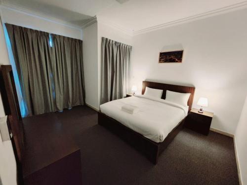 a hotel room with a bed and two lamps at Havana Holiday Homes Oud Metha in Dubai