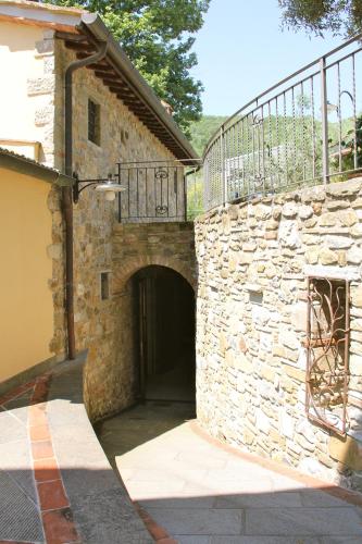 an entrance to a stone building with a balcony at Podere Del Griccia in Civitella in Val di Chiana