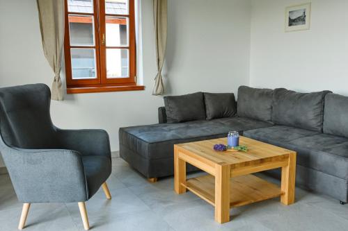 a living room with a couch and a coffee table at Chalupa Pod Šerovnou in Prachatice