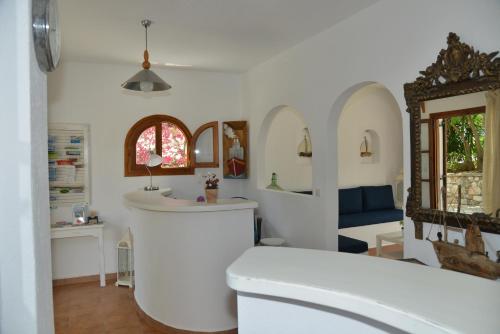 a bathroom with a white toilet and a sink at Anofli Suites in Skopelos Town