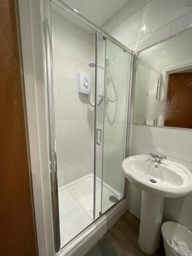 a bathroom with a shower and a sink at Blackheath Stay in London