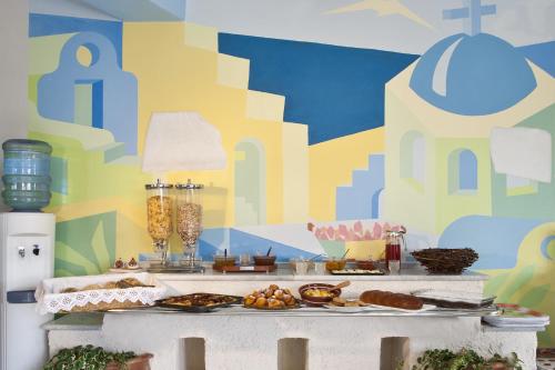 a table with food on it with a colorful wall at Naxos Kalimera Apartments in Agia Anna Naxos