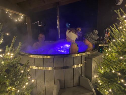a man in a hot tub in a christmas tree at Evin*raj in Kvačany