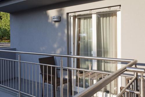 a balcony with a chair and a window at Primus Hotel & Apartments in Vienna