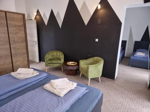 a bedroom with two beds and two chairs at Apart.5 locuri centru Cristian in Cristian