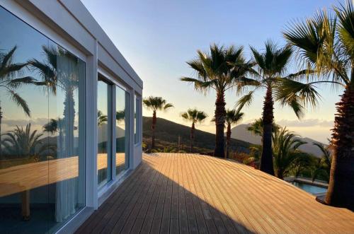 a balcony of a house with palm trees at The Nest Tenerife in Arona