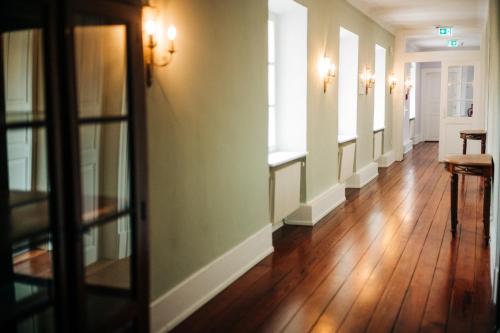 a hallway of a building with wooden floors and lights at Schloss Neckarbischofsheim in Neckarbischofsheim