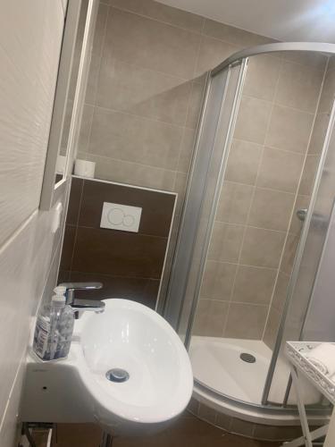 a small bathroom with a sink and a shower at Joel Living in Hannover