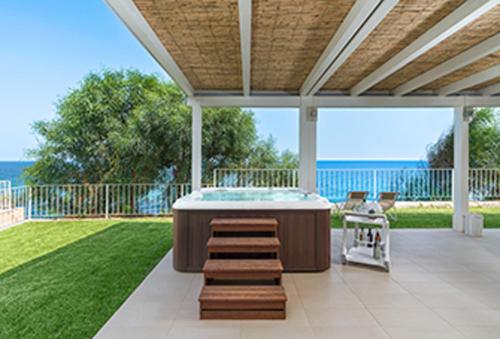 a hot tub on a patio with a view of the ocean at Stella Maris in Noto Marina