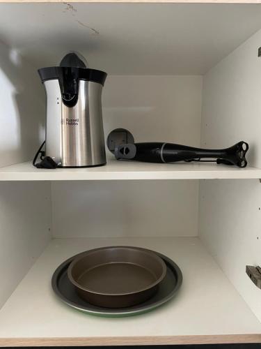 a frying pan and a pot on a shelf in a kitchen at * Chic Business Evasion * - SOnights in Brétigny-sur-Orge
