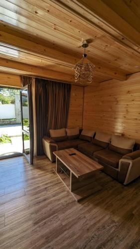 a living room with a couch and a table at Taripiri in Ambrolauri