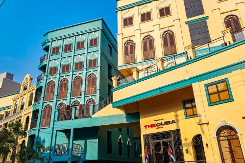 a building with a clock tower on top of it at The Quba Boutique Hotel Pattaya in Pattaya Central