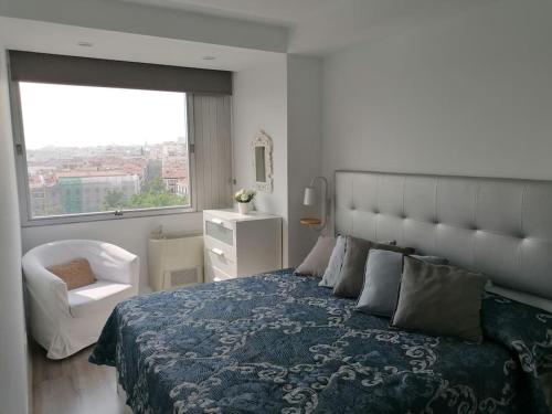 1 dormitorio con 1 cama grande y ventana grande en Colón Vistas en Madrid