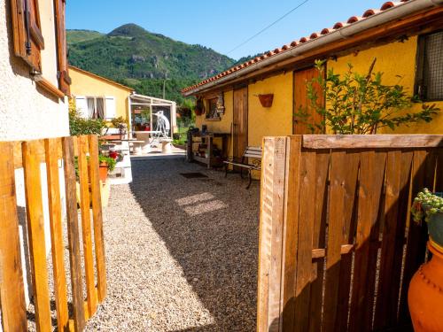 a wooden fence in front of a house at Maison de vacances in Bompas