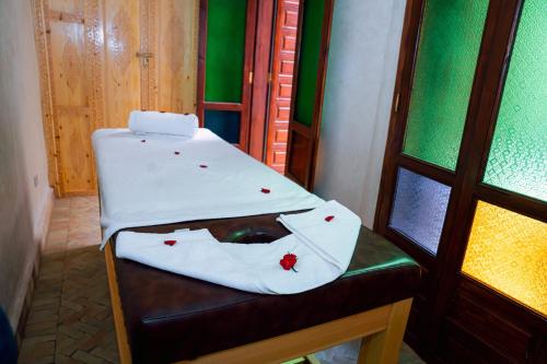 a chair with a towel on it next to a window at Riad Dar Zaouia in Marrakech