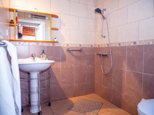 a bathroom with a shower and a sink at Maison de vacances in Bompas