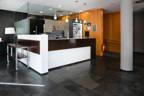 a lobby with a white and brown counter top at AS Porta de Barcelona in Castellbisbal