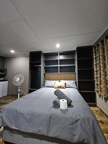 a bedroom with a large bed with a large headboard at Matusadona Guest Lodge in Hillcrest