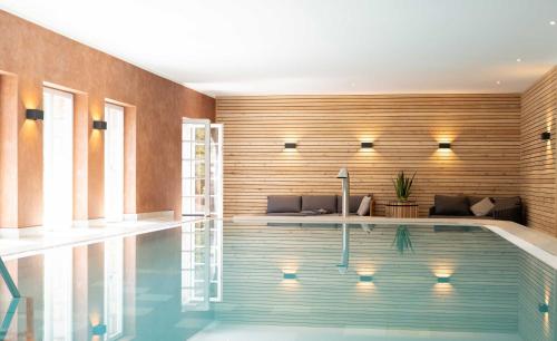 a swimming pool in a house with a wooden wall at Bernstein Schlosshotel Ballenstedt in Ballenstedt