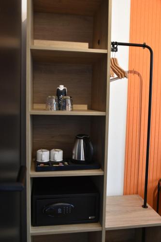a book shelf with a stove and pots and pans at ClapClap Hôtel, Food & Bar in Strasbourg