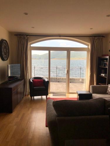a living room with a large window with a view of the ocean at Seaview Reenellen in Valentia Island
