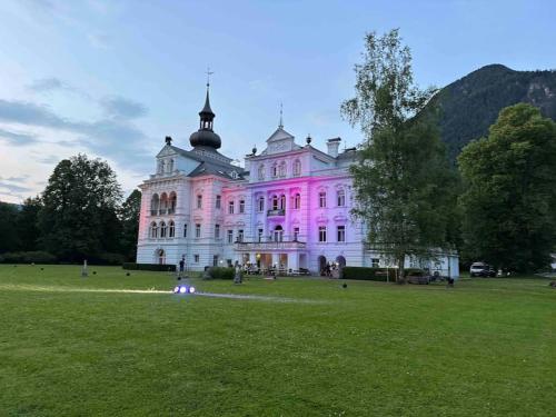 a large building with a pink light on it at Grubhof Studio mit Indoor Pool und Garten in Sankt Martin bei Lofer