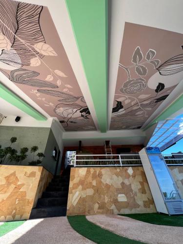 a building with a mural on the ceilings at Munduk Kupang Sekumpul Villa in Singaraja