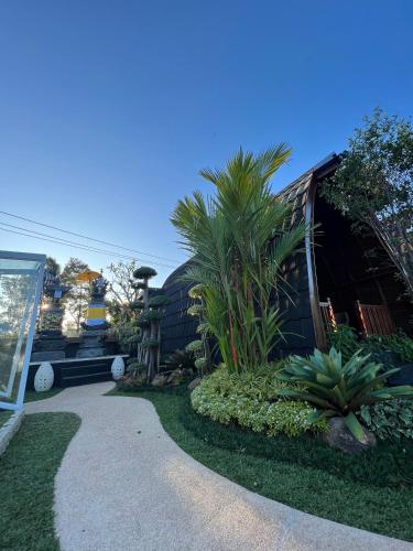 a house with a pathway leading to a yard with plants at Munduk Kupang Sekumpul Villa in Singaraja