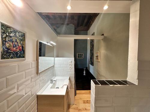 a bathroom with a sink and a mirror at L'Auditoire Royal in Châtillon-sur-Seine