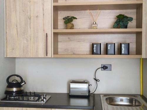 a kitchen with a sink and a counter top at Tshepang Apartments Secunda in Secunda