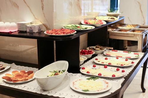 a buffet with many plates of food on a table at AXU AIRPORT HOTEL in Arnavutköy