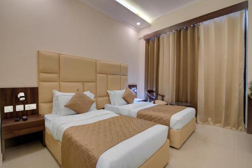 A bed or beds in a room at Comfort Inn Karnal