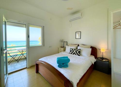 a bedroom with a bed with a blue toy on it at Beach Front Villa in Shave Ẕiyyon