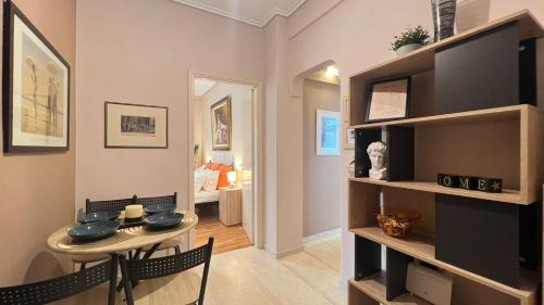 a living room with a small table and a dining room at Koukaki Cozy Studio Retreat 1' from metro in Athens