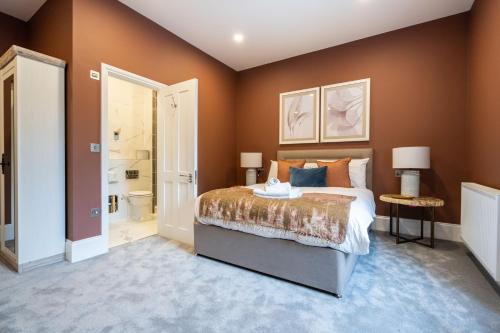 a bedroom with a bed and a bathroom at Old Abbey House in Abingdon