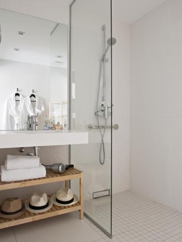 a bathroom with a shower with a glass door at Hôtel Le Rohan, centre Cathédrale in Strasbourg