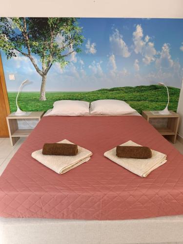 a large bed with two towels on top of it at AZORES HOLIDAYS HOUSE -B&B - Suites - Self Check-in KEYBOARD in Ponta Delgada