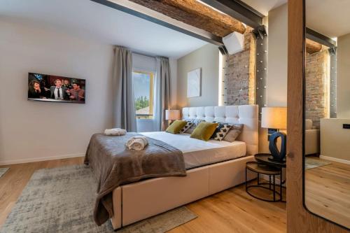 a bedroom with a bed and a brick wall at Borgo Rotondo in San Giovanni in Persiceto