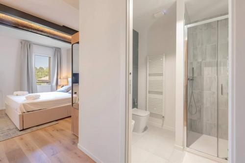 a bedroom with a bed and a bathroom with a shower at Borgo Rotondo in San Giovanni in Persiceto