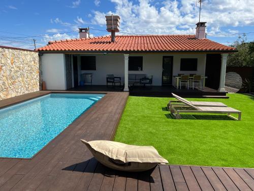 a villa with a swimming pool and a house at Casa da Ti Bemvinda in Helenos