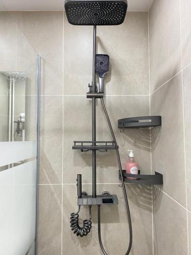 a shower with a shower head in a bathroom at Chez les deux garçons in Montrouge